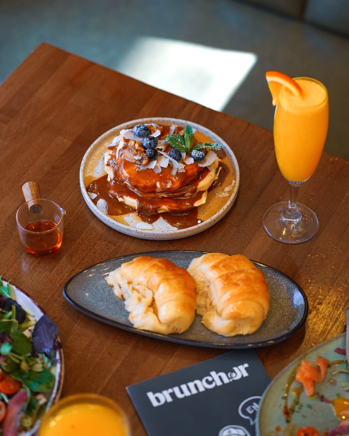 Brunch spread with pancakes, pastries and fresh juice