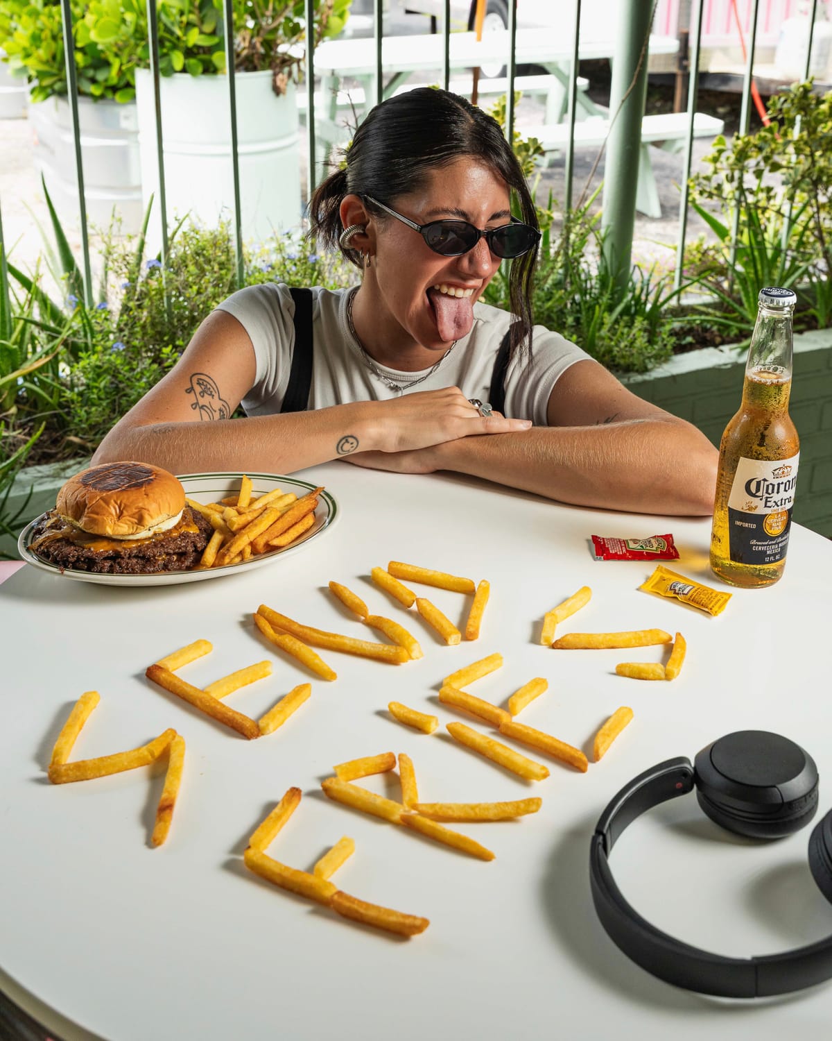 Fries arranged to spell a message beside a burger