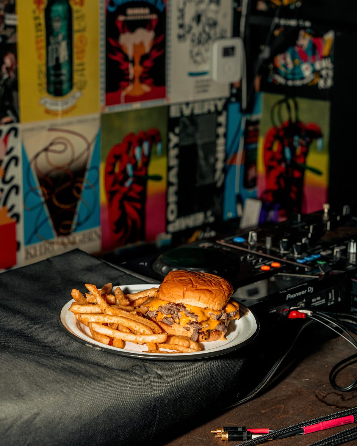 Burger and fries styled on a DJ setup
