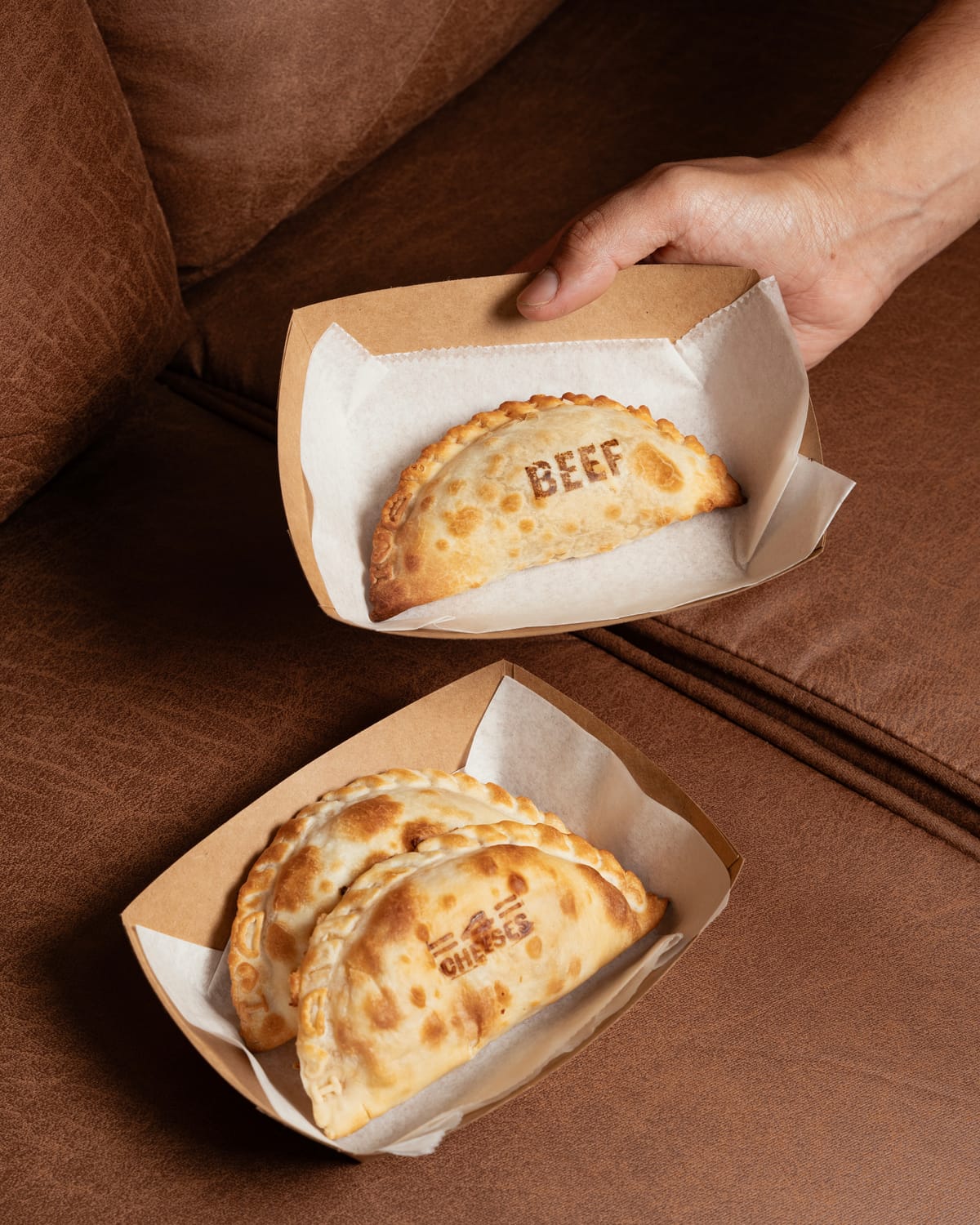 Beef empanadas in branded takeaway sleeves