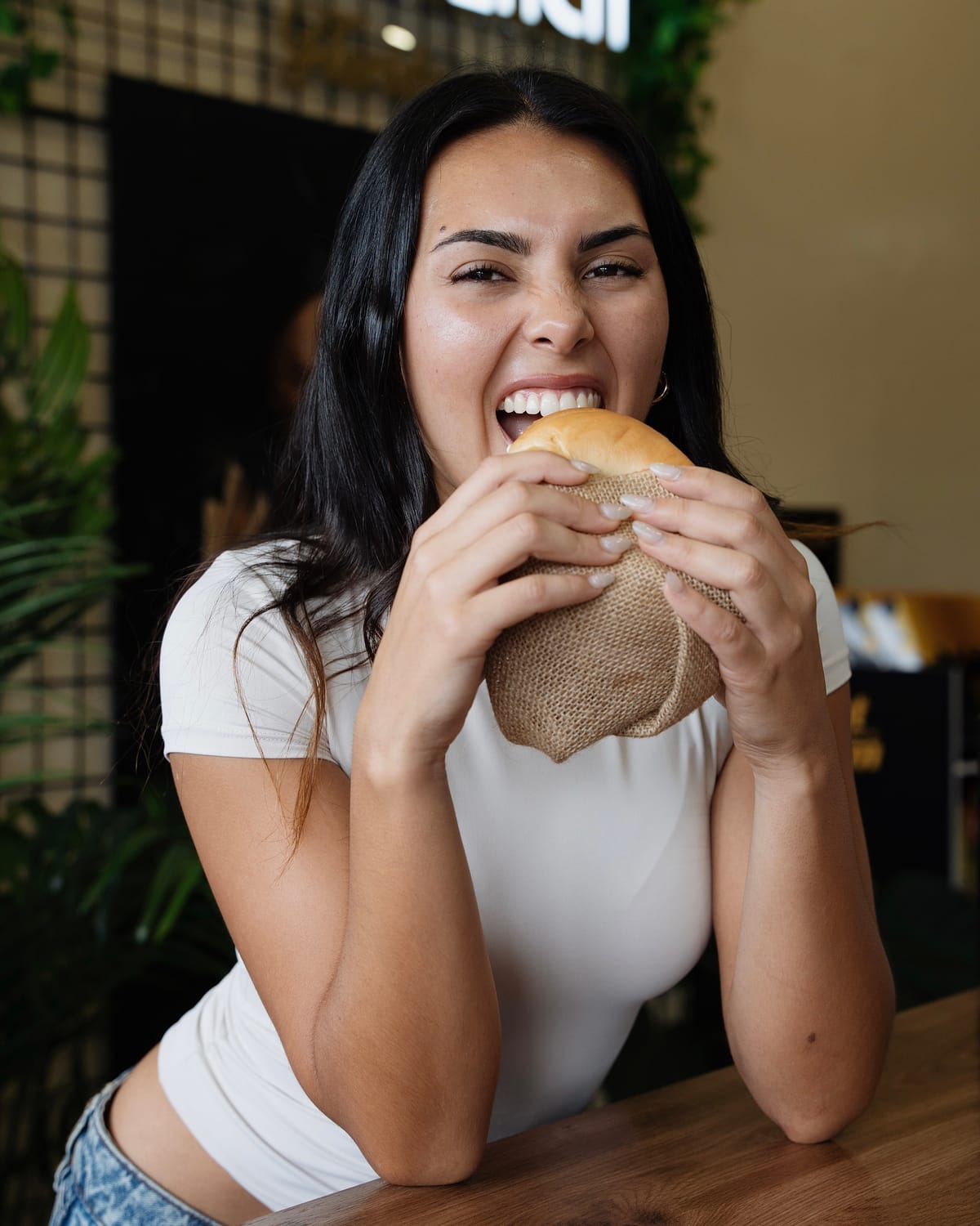 Close-up portrait biting into a burger